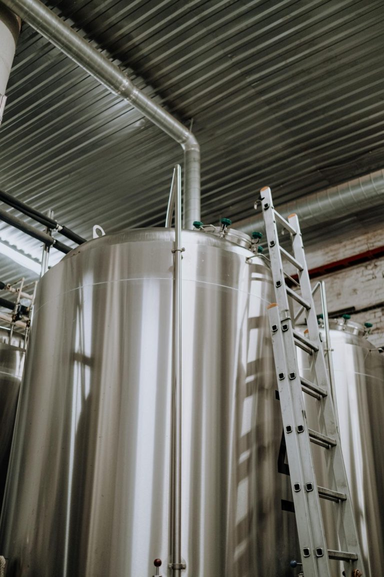 A Steel Ladder Leaning on Stainless Steel Tank