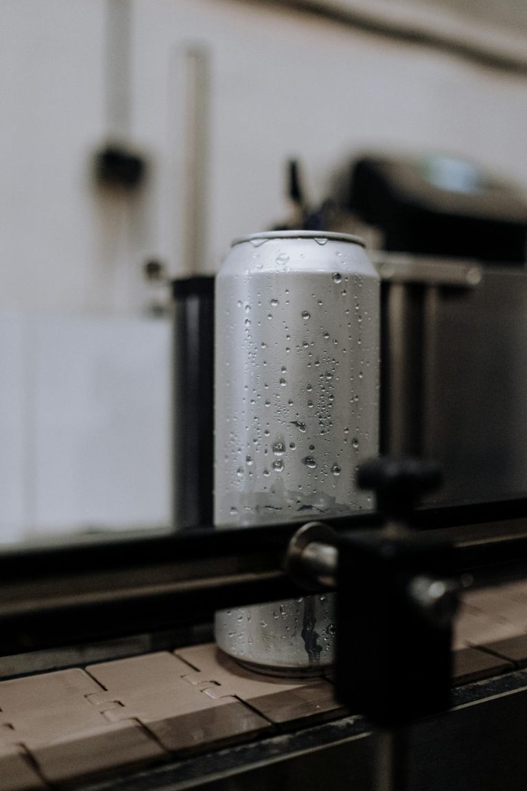 Gray Steel Container on Brown Wooden Table